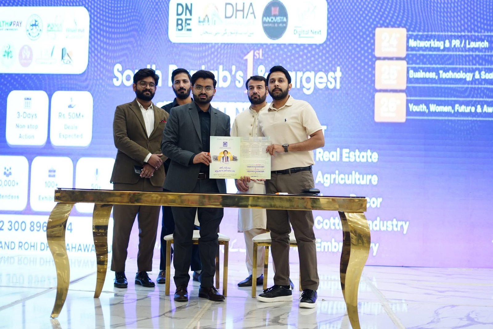 Digital Next team members display an award together
