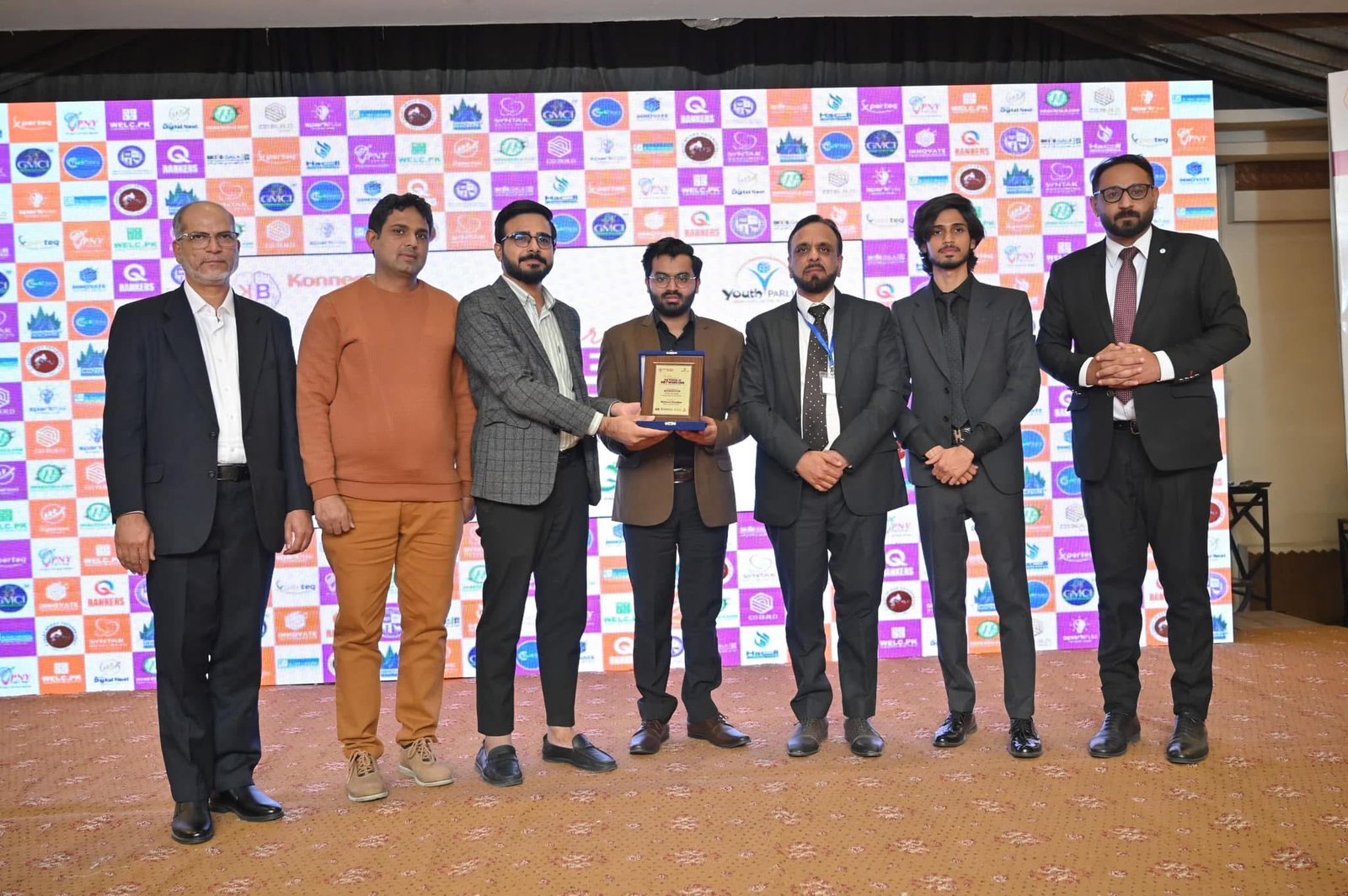 Digital Next team members display an award together